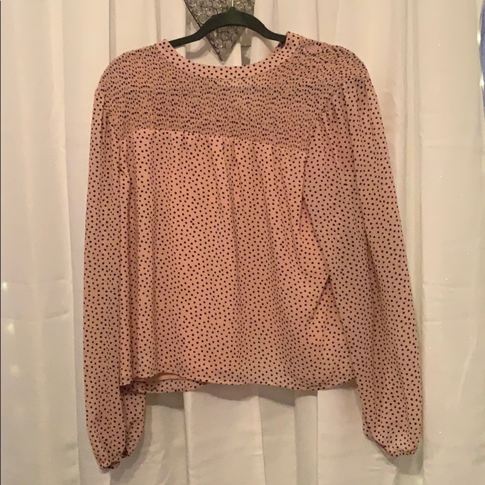 Pink shirt with black polka dots.